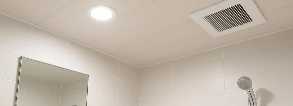 PVC ceiling planks above a bathtub. The surface beads condensation and dries without leaving watermarks. After ten years of daily shower steam exposure, this ceiling will show the same surface finish as day one. PVC ceiling planks above a bathtub. The surface beads condensation and dries without leaving watermarks. After ten years of daily shower steam exposure, this ceiling will show the same surface finish as day one.